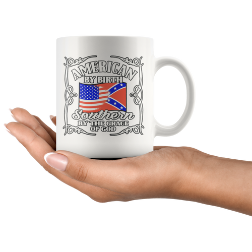 "American By Birth Southern By The Grace Of God Wht" mug with patriotic and Southern heritage design held in hand.