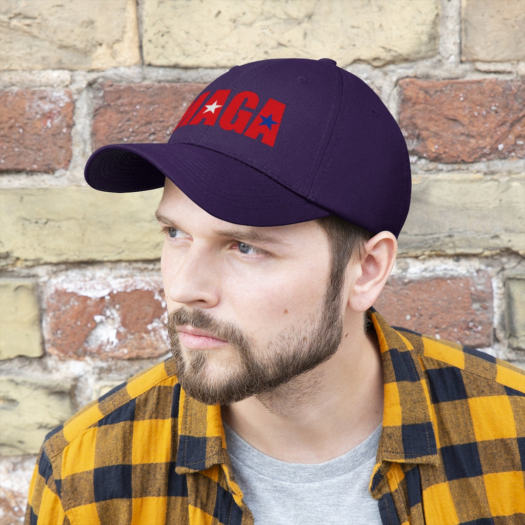 Embroidered MAGA Cotton Twill Cap Design worn by a man with a beard against a brick background.