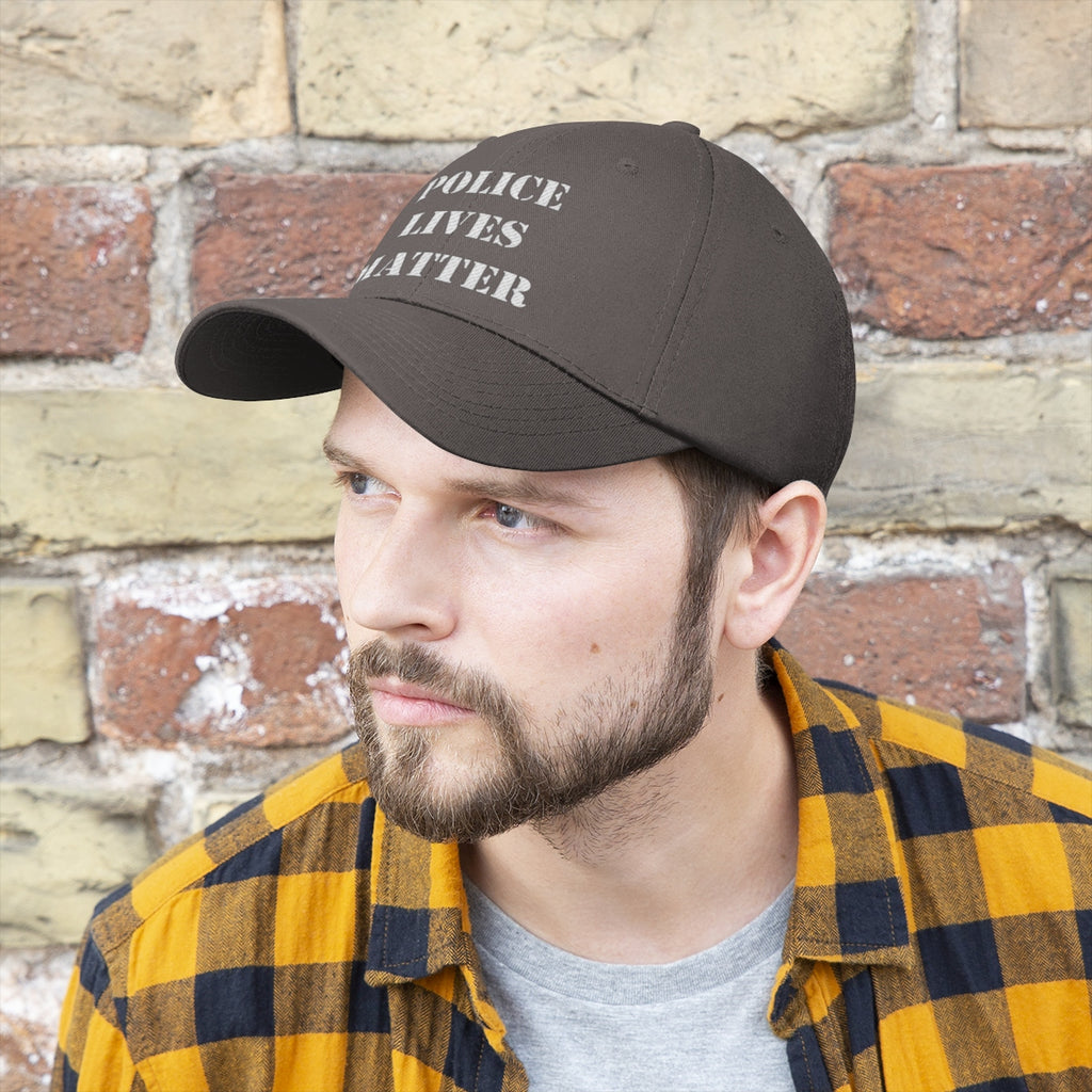 Man wearing an Embroidered Police Lives Matter Twill Cap in front of a brick wall.