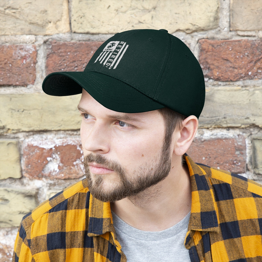 USMC Retired On Distressed American Flag Twill Cap worn by a man with a beard in front of a brick wall.