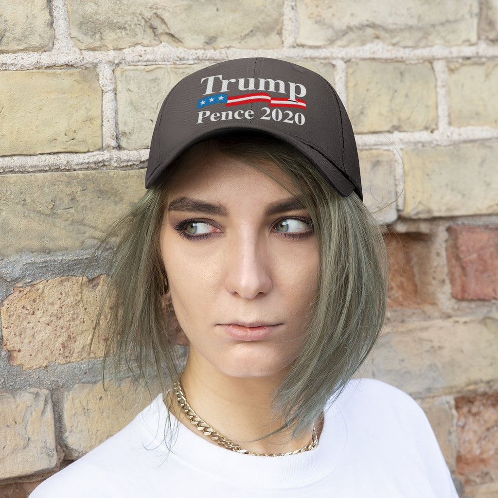 Trump Pence 2020 American Flag Twill Cap worn by model against a brick wall background.
