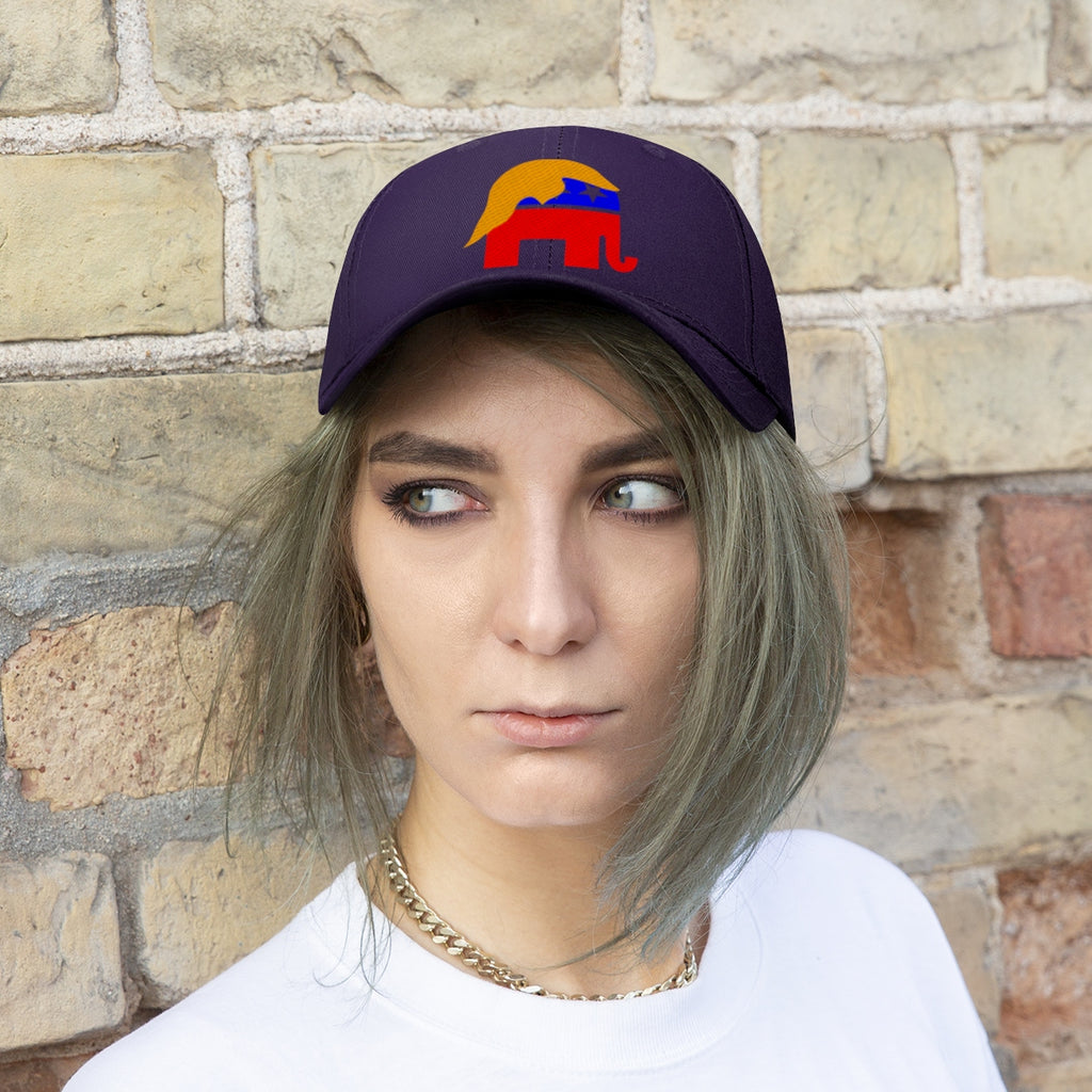 GOP Symbol With Trump Hair Twill Cap worn by a young woman with short hair, against a brick wall background.