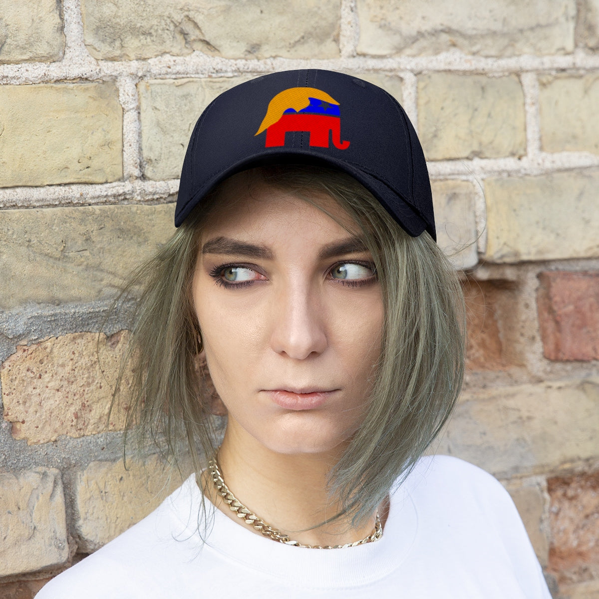 GOP Symbol With Trump Hair Twill Cap worn by a model against a brick wall background.