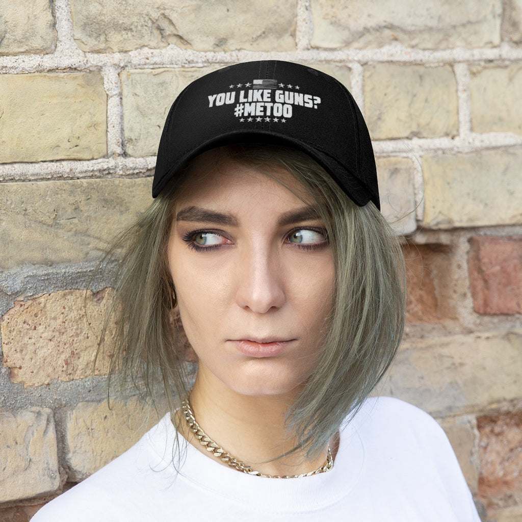 Woman wearing You Like Guns Me Too Twill Cap in front of a brick wall, showing bold patriotism and style.