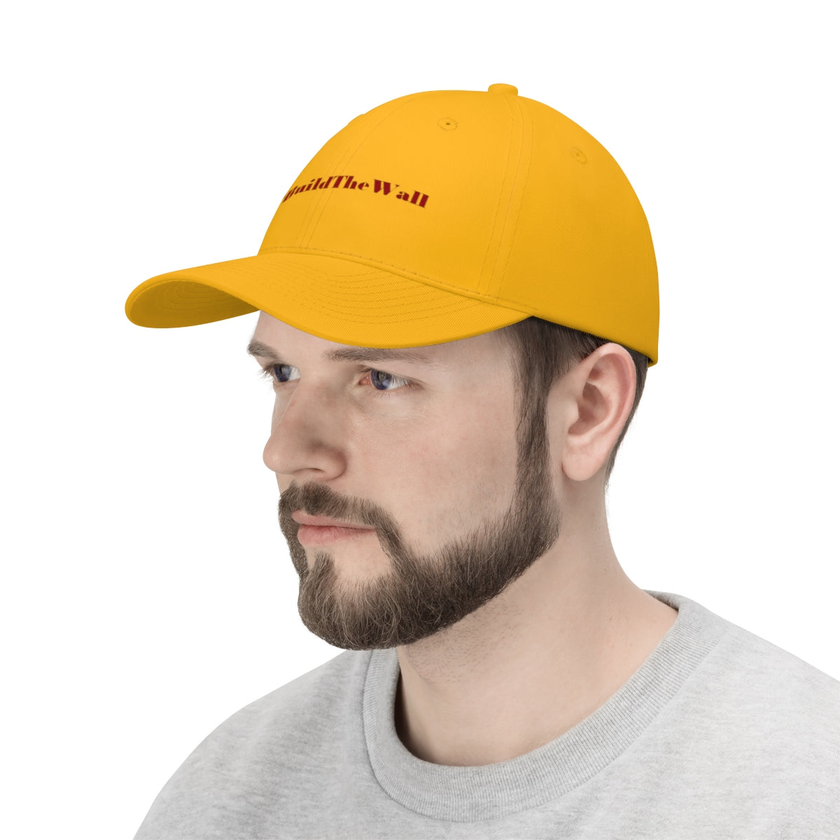 Build The Wall Twill Cap Political Statement Casual Cap worn by a man in a yellow baseball cap.