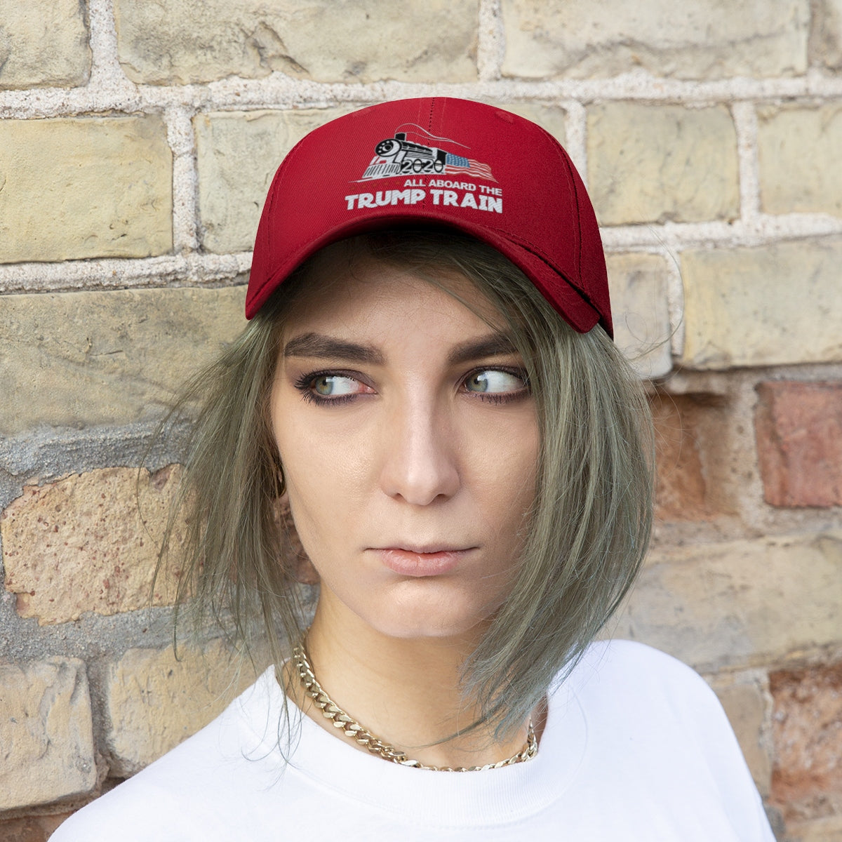 Person wearing a red cap featuring "All Aboard The Trump Train 2020 Twill Cap" embroidered design.