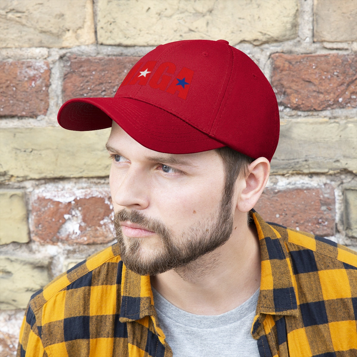 Embroidered MAGA Cotton Twill Cap Design worn by a man with a beard and plaid shirt against a brick wall.