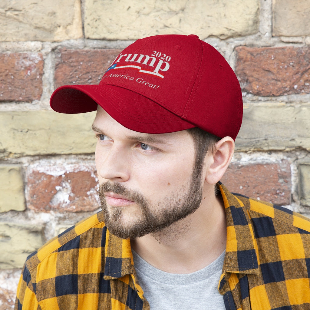 Man wearing a Trump 2020 Keep America Great Twill Cap in front of a brick wall.