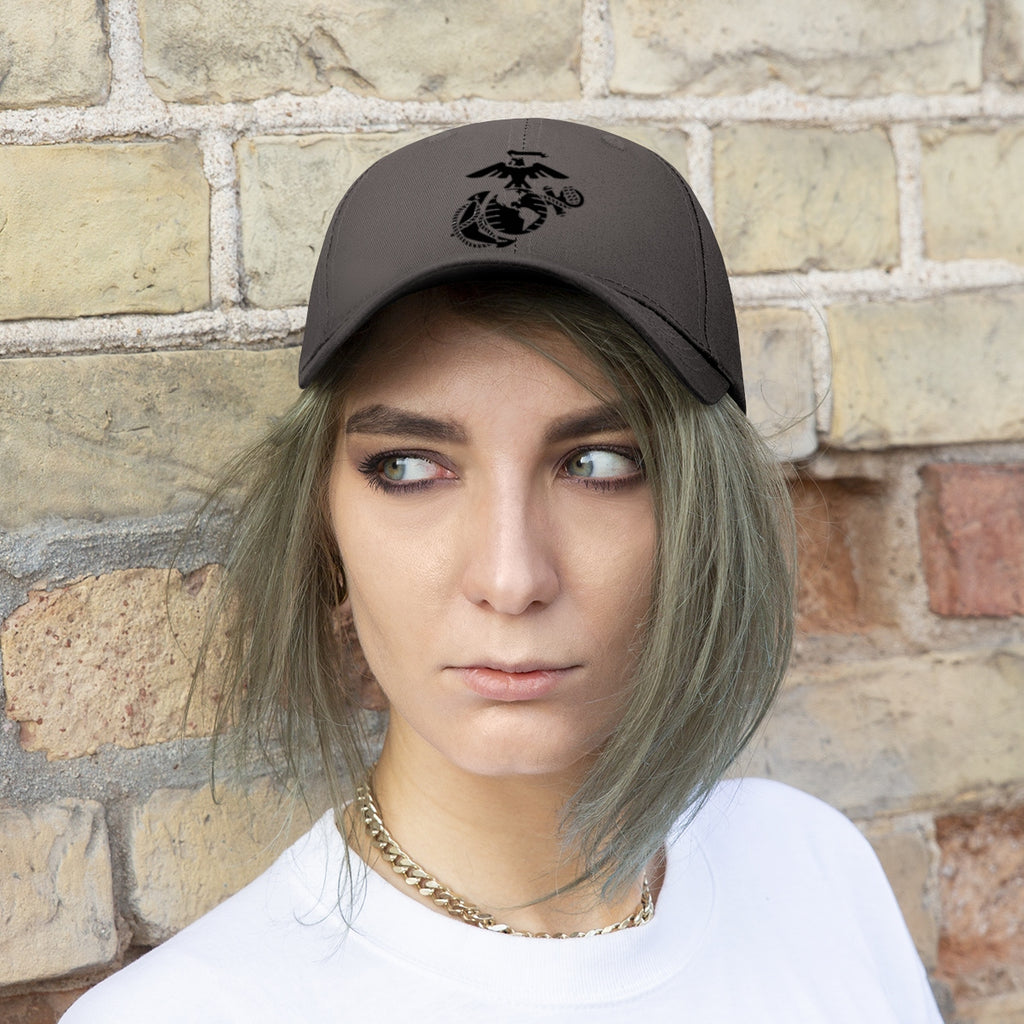 USMC Symbol Twill Cap Marine Corps Pride Hat worn by a person with short hair in front of a brick wall.