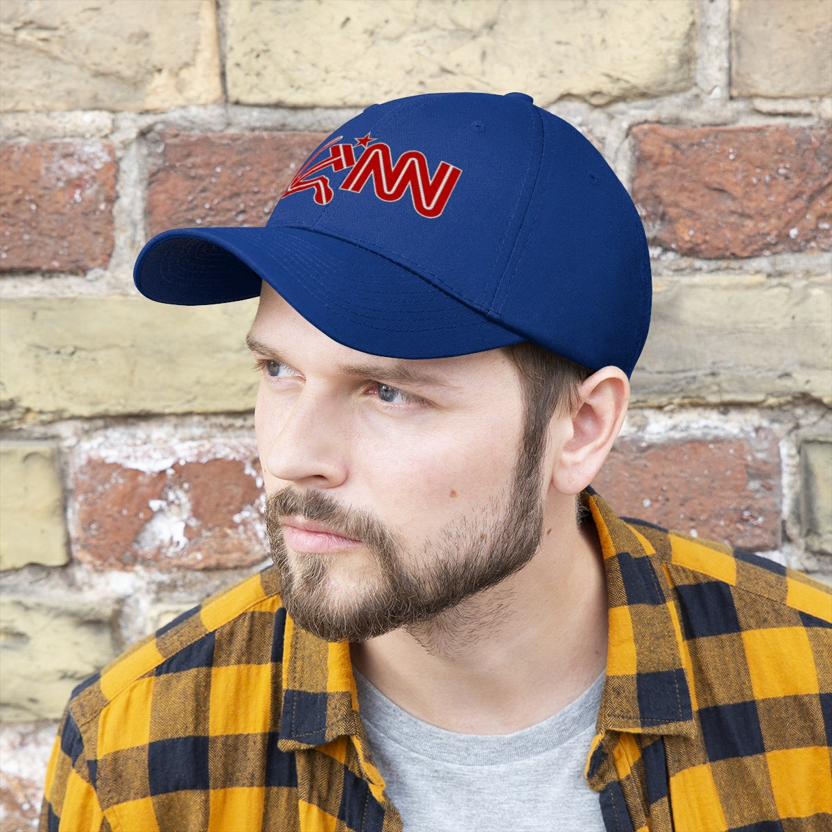CNN With Hammer And Sickle Twill Cap worn by a man, showcasing political satire headwear against a stone wall.