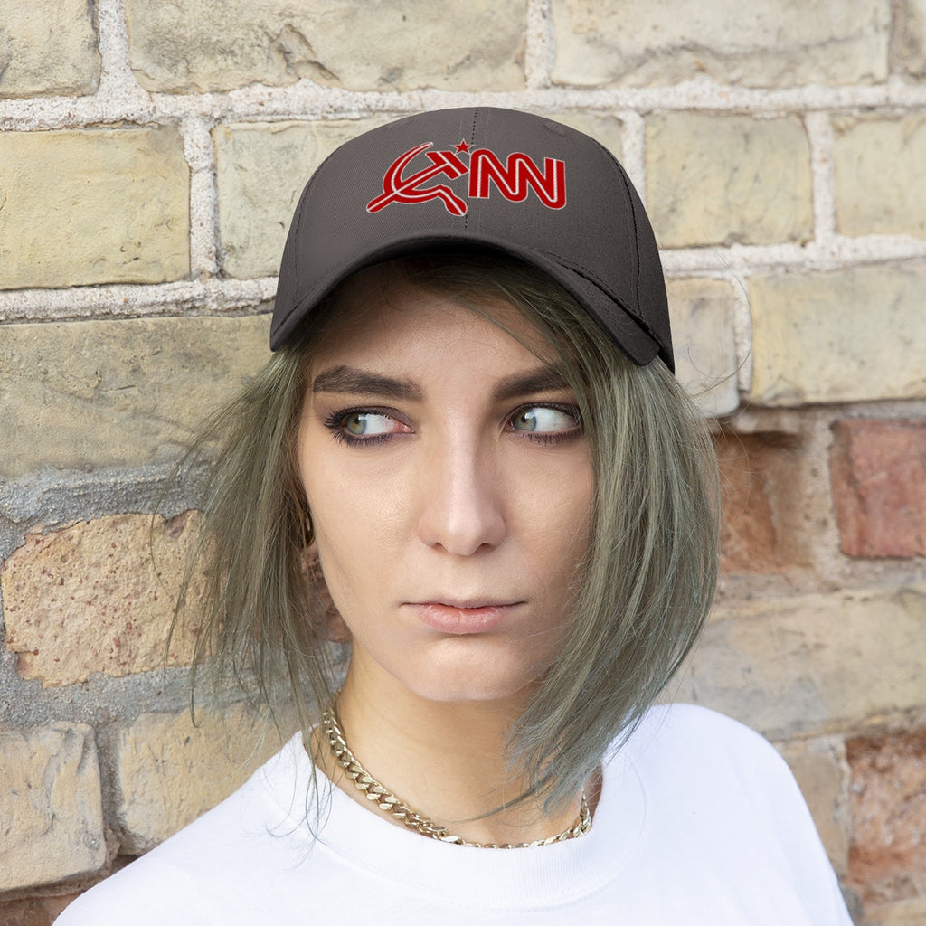 CNN With Hammer And Sickle Twill Cap worn by a model against a brick wall, showcasing political satire headwear.
