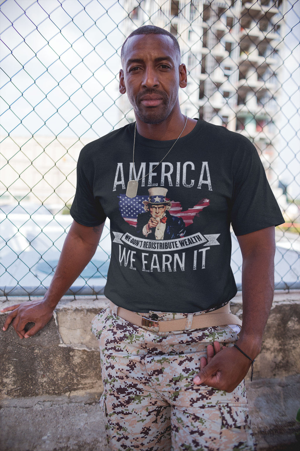 Man wearing We Earn It America Statement Shirt showcasing economic individualism and patriotism.