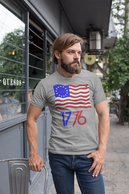 Man wearing Betsy Ross Flag 1776 Graphic Tee while standing outdoors.