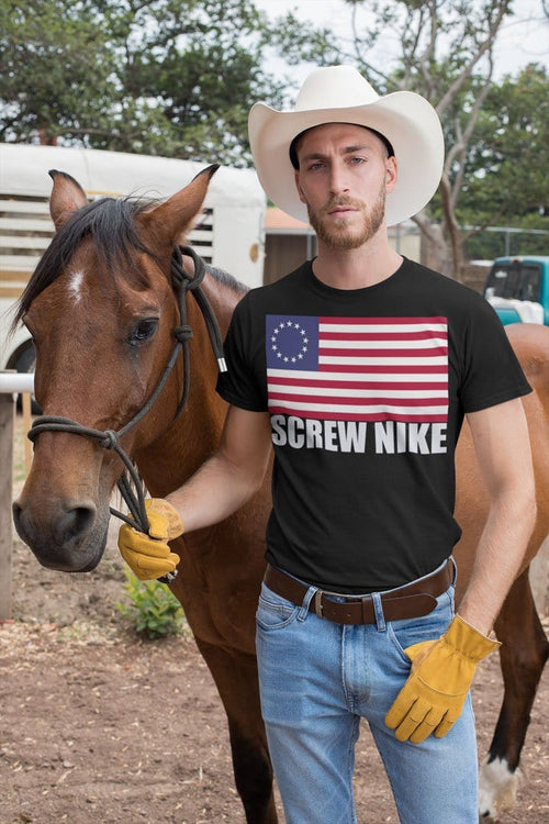 Man wearing Betsy Ross Flag Bold USA Pride Graphic Tee Shirt next to horse