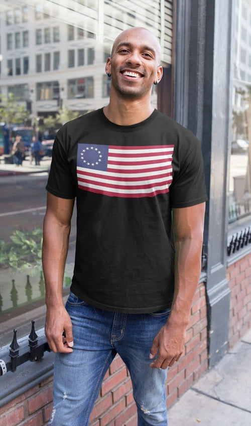 Man wearing Betsy Ross Flag Historic American Flag Graphic Tee standing on urban street