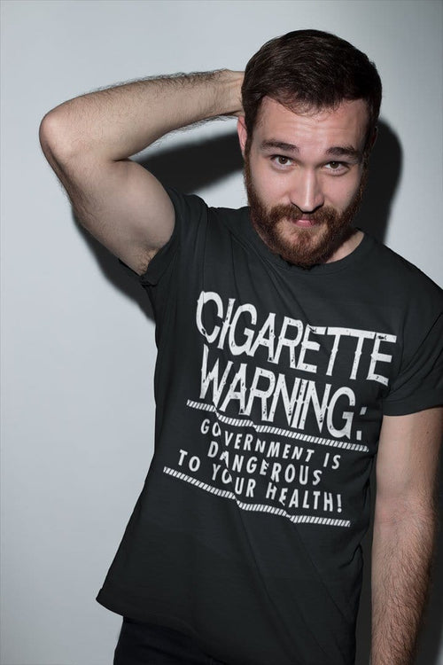 Man wearing Cigarette Warning Government Is Dangerous To Your Health T-shirt with satirical-political message.
