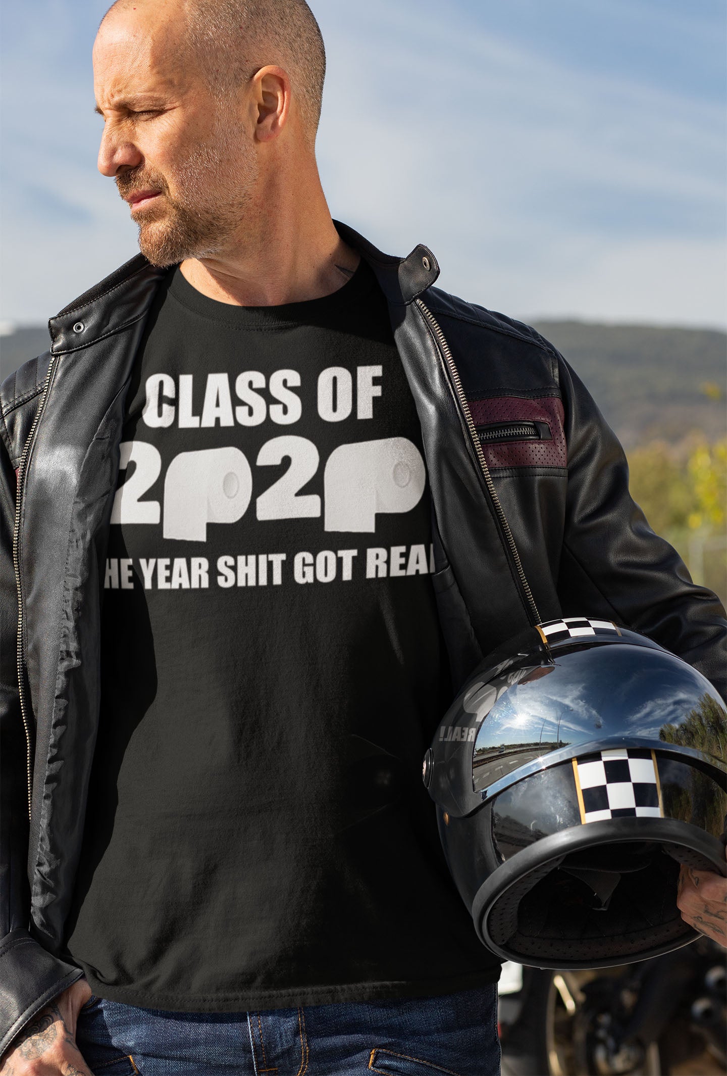 Man wearing Class Of 2020 The Year Shit Got Real t-shirt holding a helmet