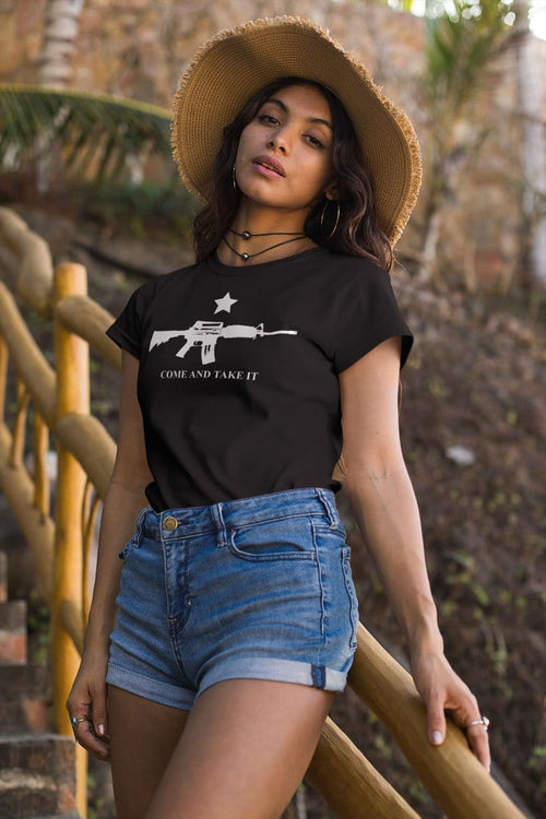 Woman wearing a Come And Take It AR-15 And Star t-shirt standing on stairs outdoors.