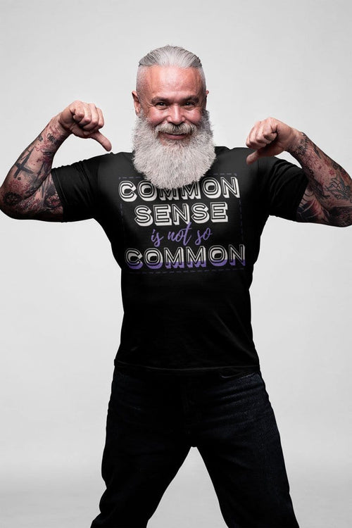 Man posing in black t-shirt with bold text 'Common Sense Iss Not So Common' design