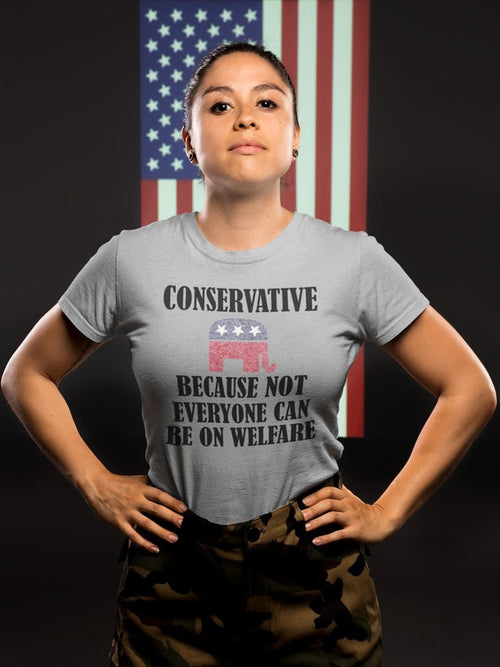 Person wearing a shirt with the text 'Conservative Because Not Everyone Can Be On Welfare' in front of a flag backdrop.