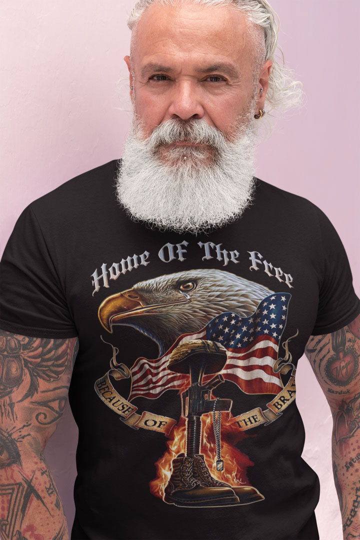 Man wearing 'Home Of The Free Because Of The Brave' patriotic t-shirt with American flag and eagle design.