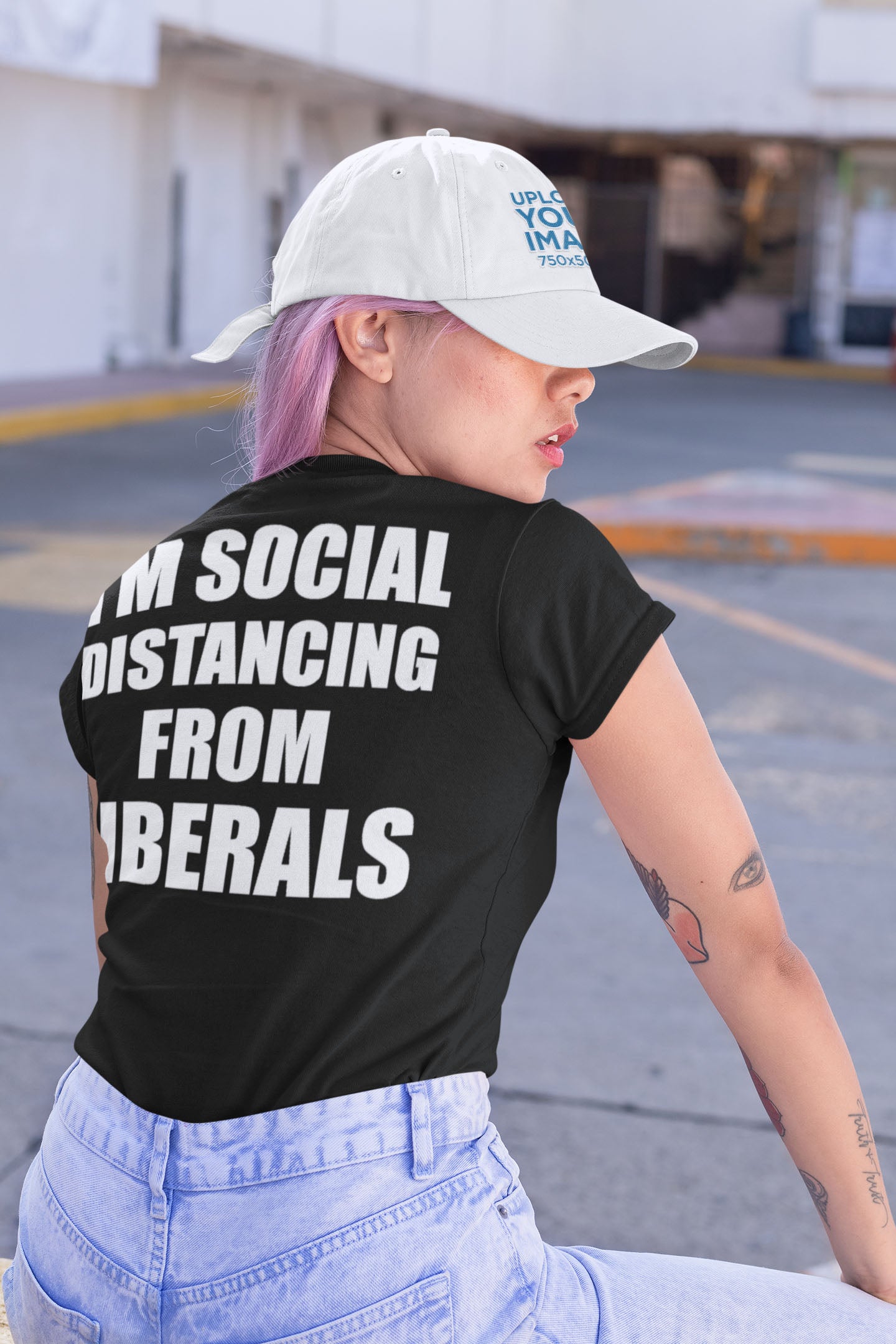 Person wearing I'm Social Distancing From Liberals Blk On Back t-shirt with bold statement in urban setting