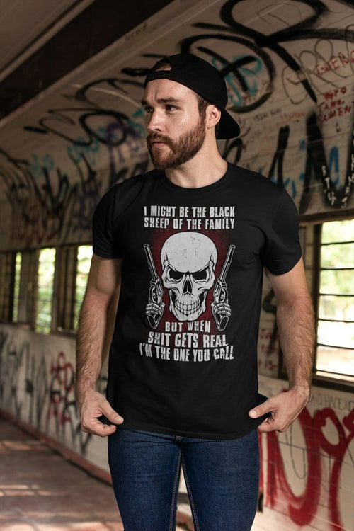 Man wearing Black Sheep Of The Family When It Gets Real Call Me Tee in urban setting.