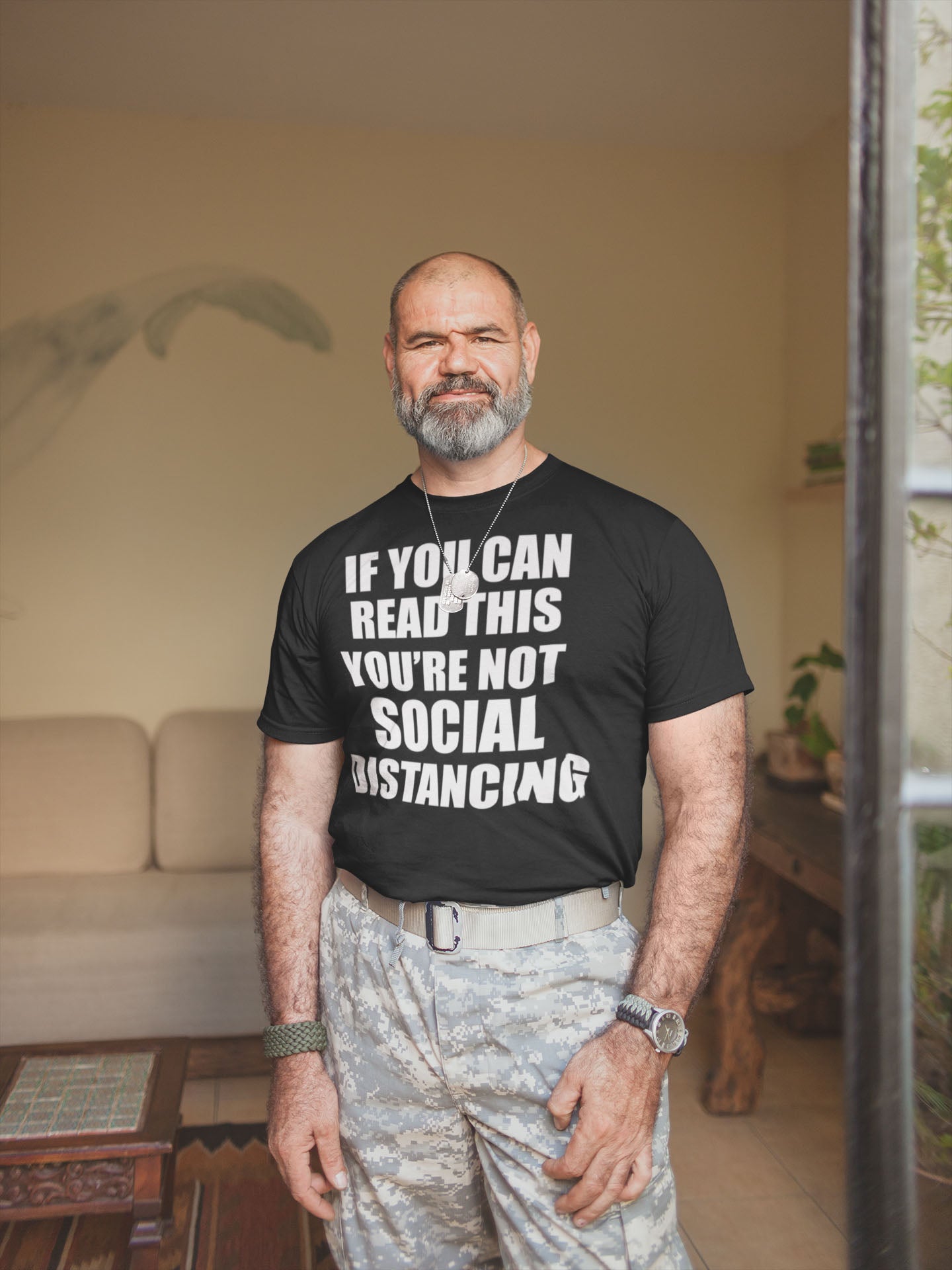 Man wearing 'If You Can Read This Not Social Distancing Statement Tee' in living room