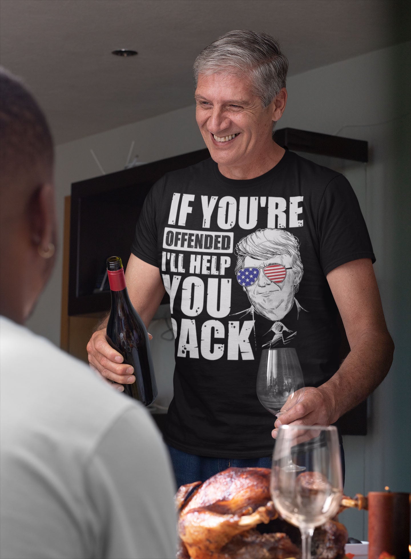 Man wearing Patriotic Trump USA Sunglasses Design Shirt, holding wine at a dinner table.