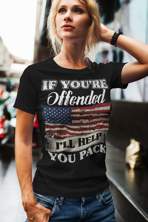Woman wearing Bold Statement Humor Graphic Tee with an American flag design and humorous text, standing outside in casual jeans.