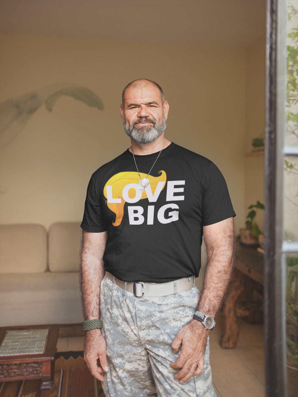 Man wearing Love Big With Hair 2 Trump Humor Statement Tee in casual setting.