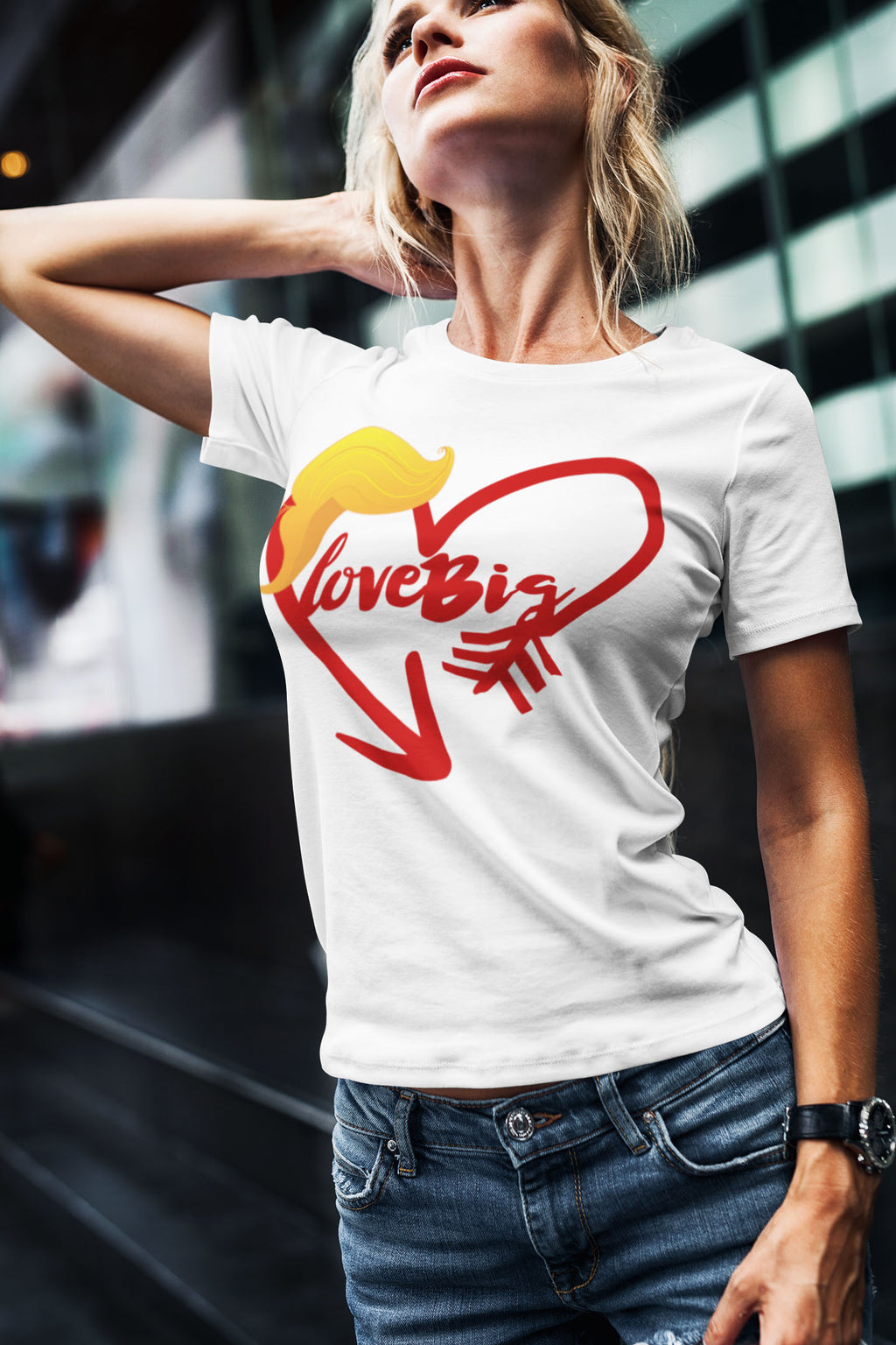Woman wearing Love Big with Trump Hair Graphic Tee in urban setting.