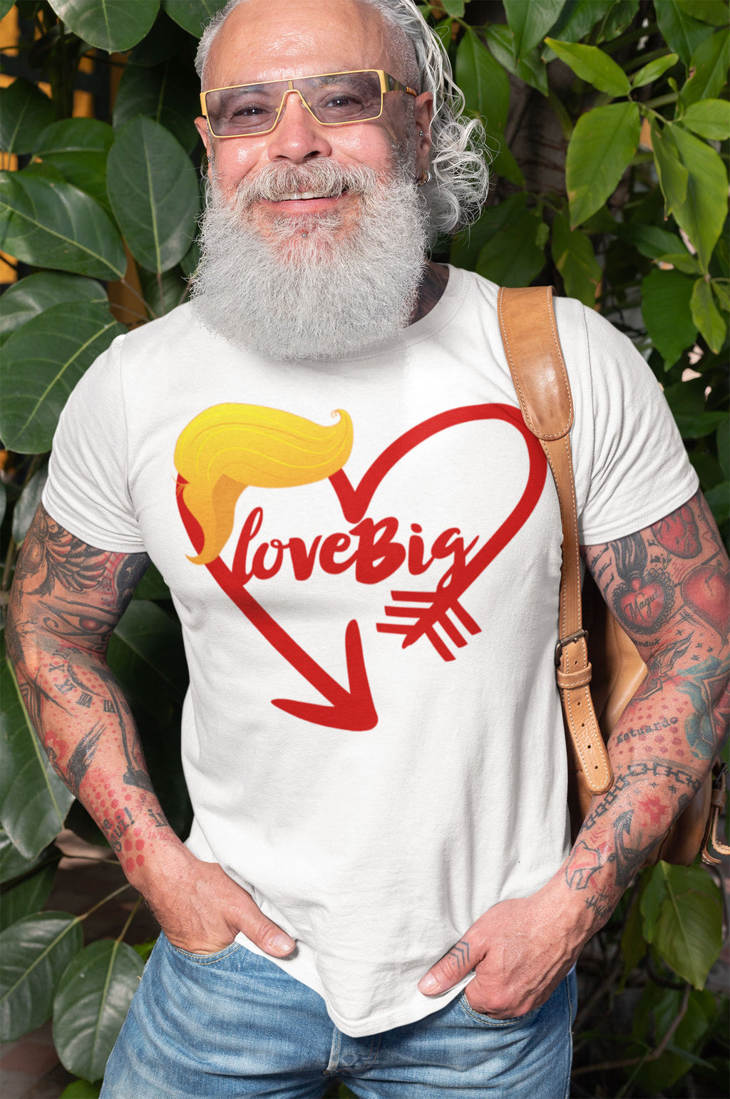 Man wearing Love Big with Trump Hair Graphic Tee in a garden