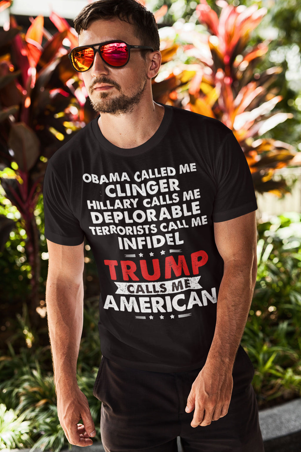 Man wearing Patriotic Political Quote Graphic Shirt with bold text in garden setting.