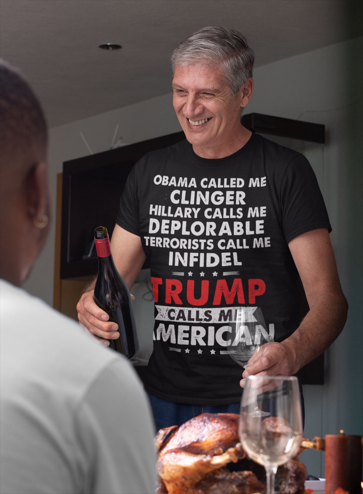 Man wearing "Trump Calls Me American" Patriotic Political Quote Graphic Shirt serving wine at a dinner table.
