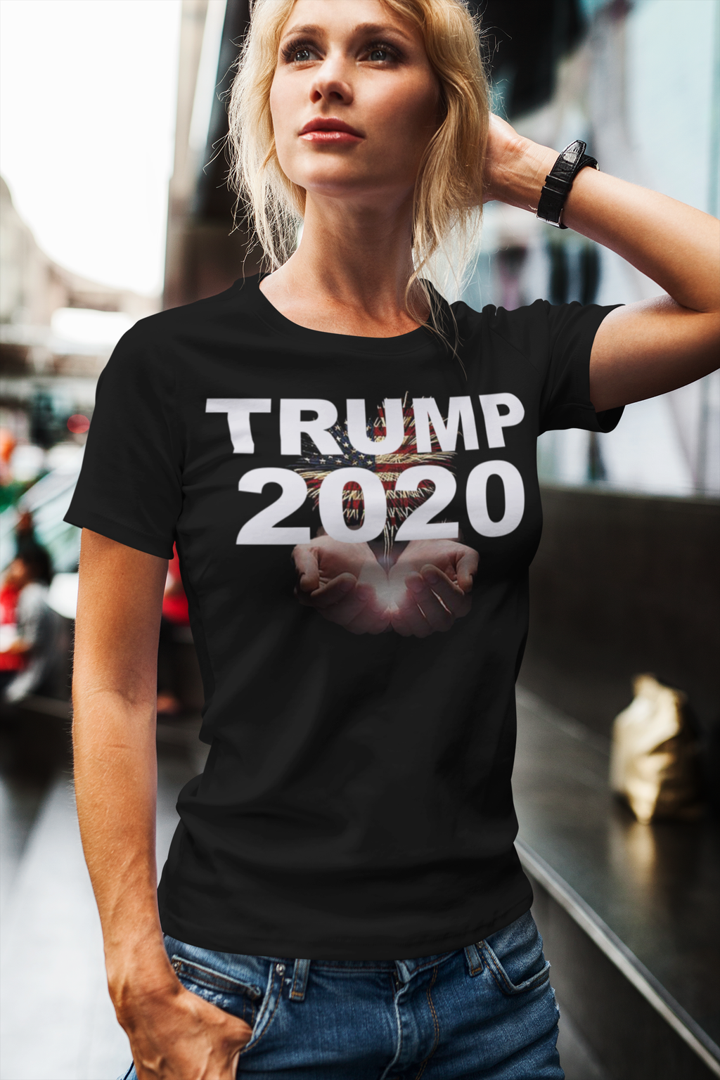 Trump 2020 Heavenly Hands Patriotic Tee worn by a woman in a city setting, featuring symbolic raised hands.