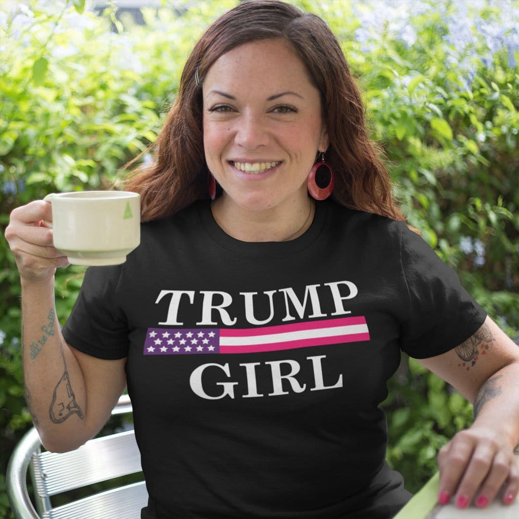 Woman wearing Girl Trump Bold Supporter Graphic Tee Shirt and holding a coffee cup outdoors.