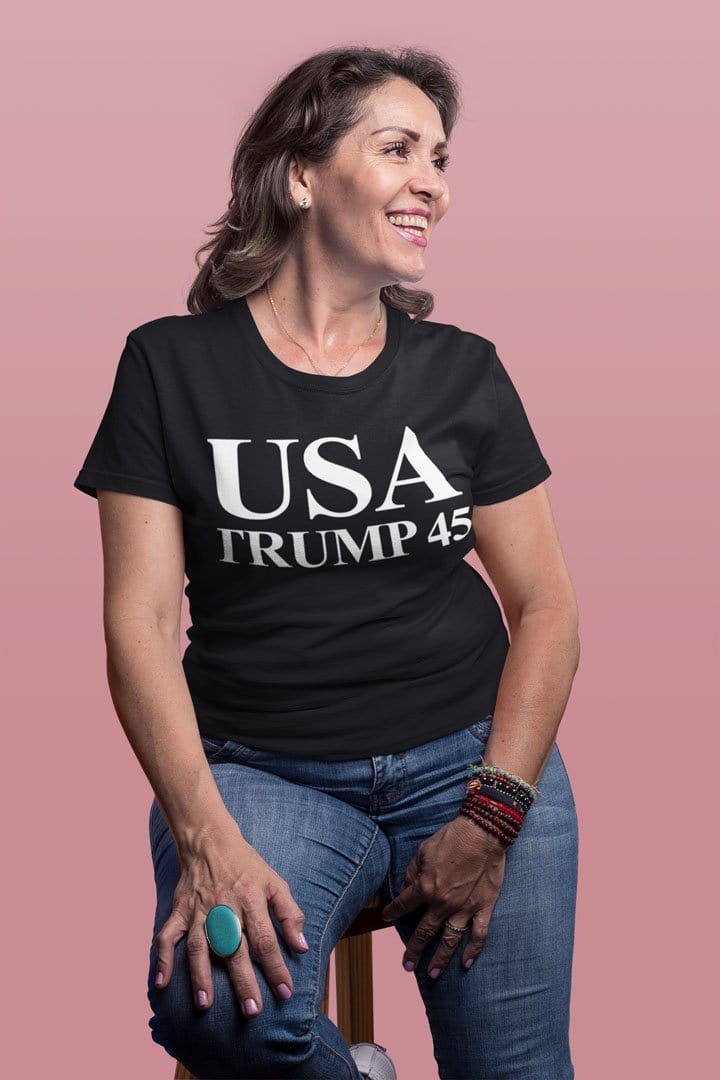 Smiling woman wearing USA 45 Trump Patriotic Supporter Graphic Tee Shirt, showcasing political enthusiasm and patriotic spirit.