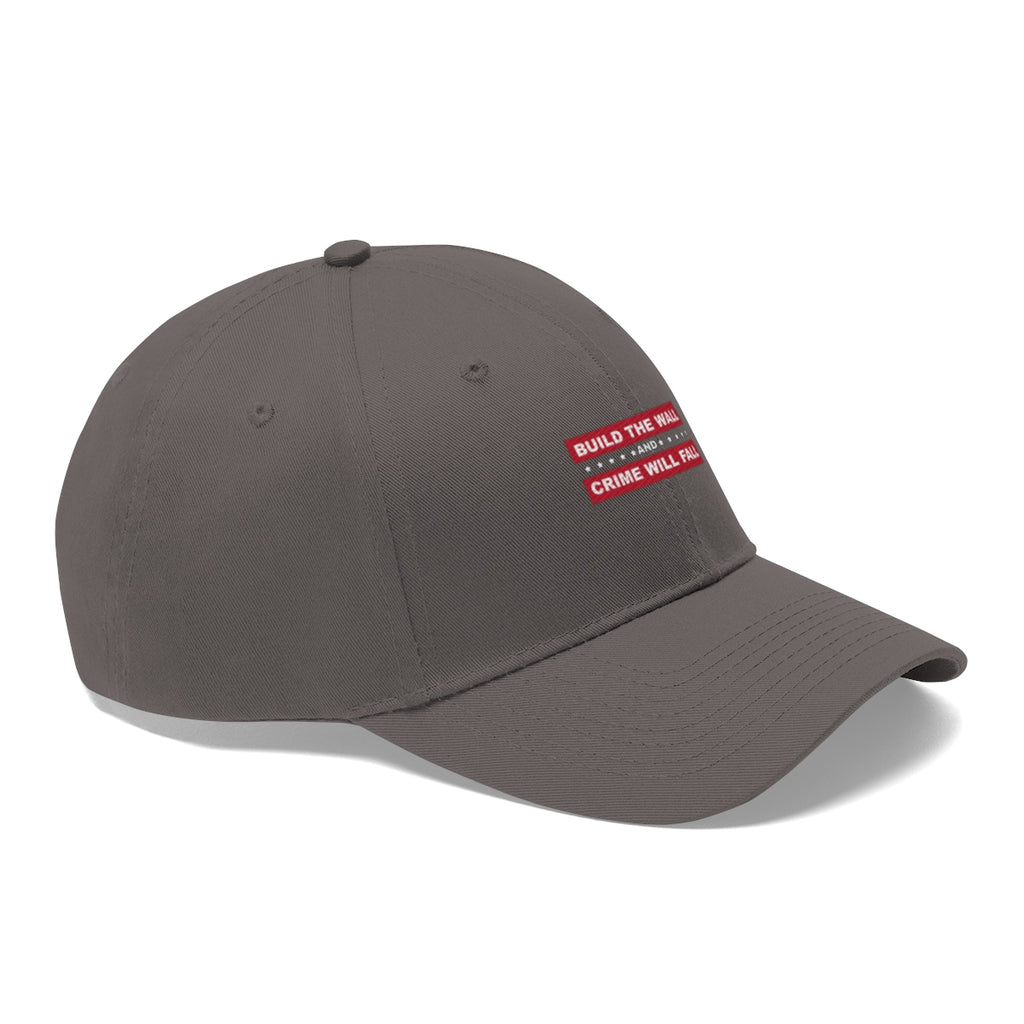 Build The Wall And Crime Will Fall Twill Cap in gray with red text on the front.