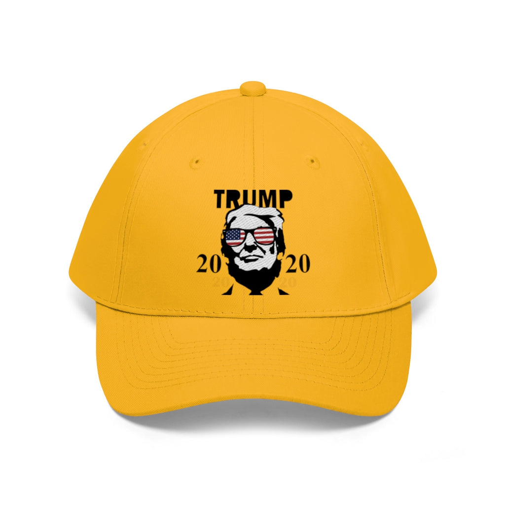 Trump 2020 With US Flag Glasses Twill Cap in vibrant yellow featuring a Trump graphic design.