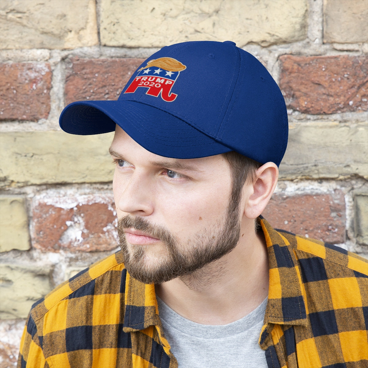 Hair 2020 Twill Baseball Cap Featuring Trump worn by a man with a beard and plaid shirt, set against a brick wall.