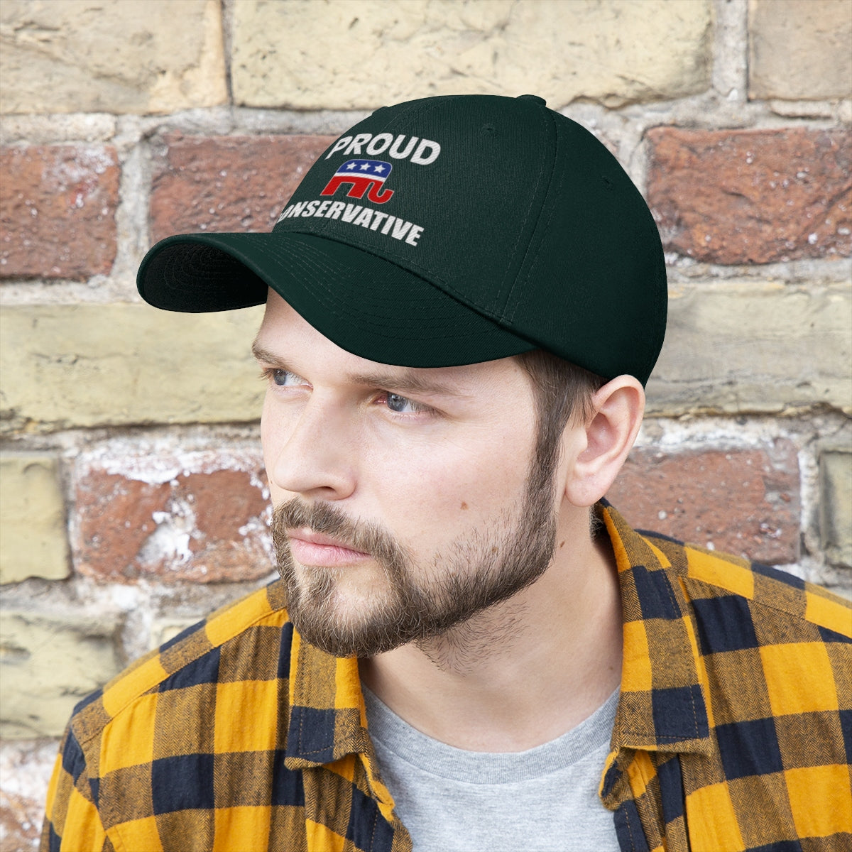 Classic Proud Conservative Twill Baseball Cap worn by a man with a beard, showcasing a political message on a dark background.