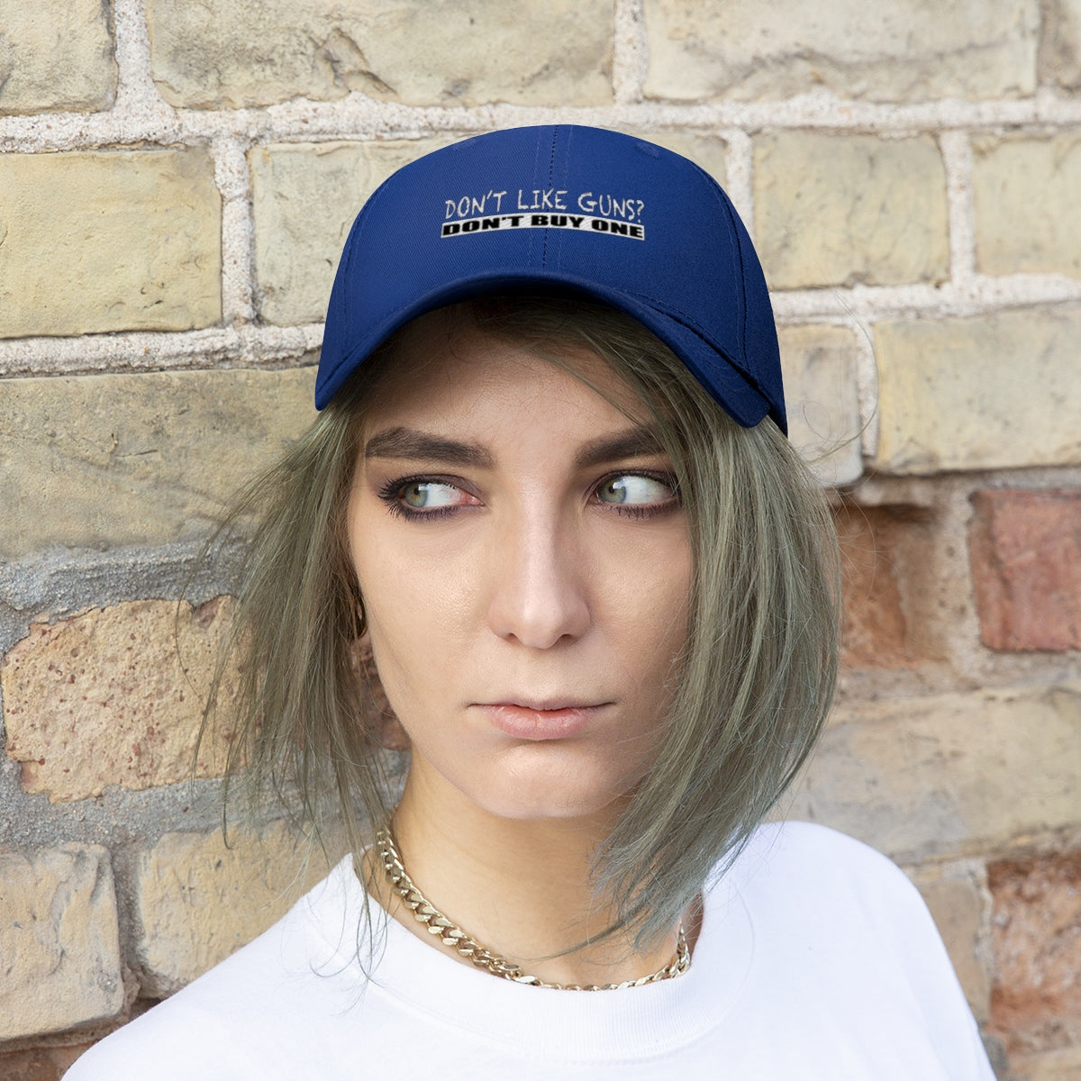 Don't Like Guns Don't Buy One Twill Cap worn by a model against a brick wall.