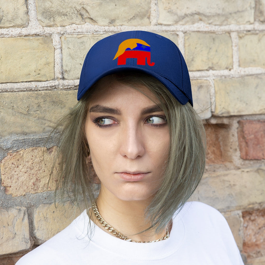 GOP Symbol With Trump Hair Twill Cap worn by a model, showcasing the vibrant design against a brick wall.