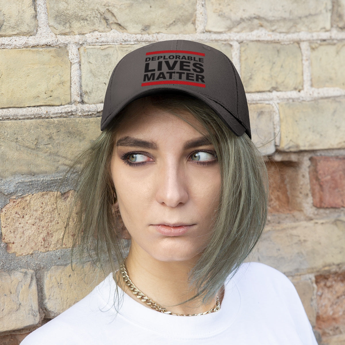 Deplorable Lives Matter Twill Cap worn by a person against a brick wall, showcasing bold political expression.