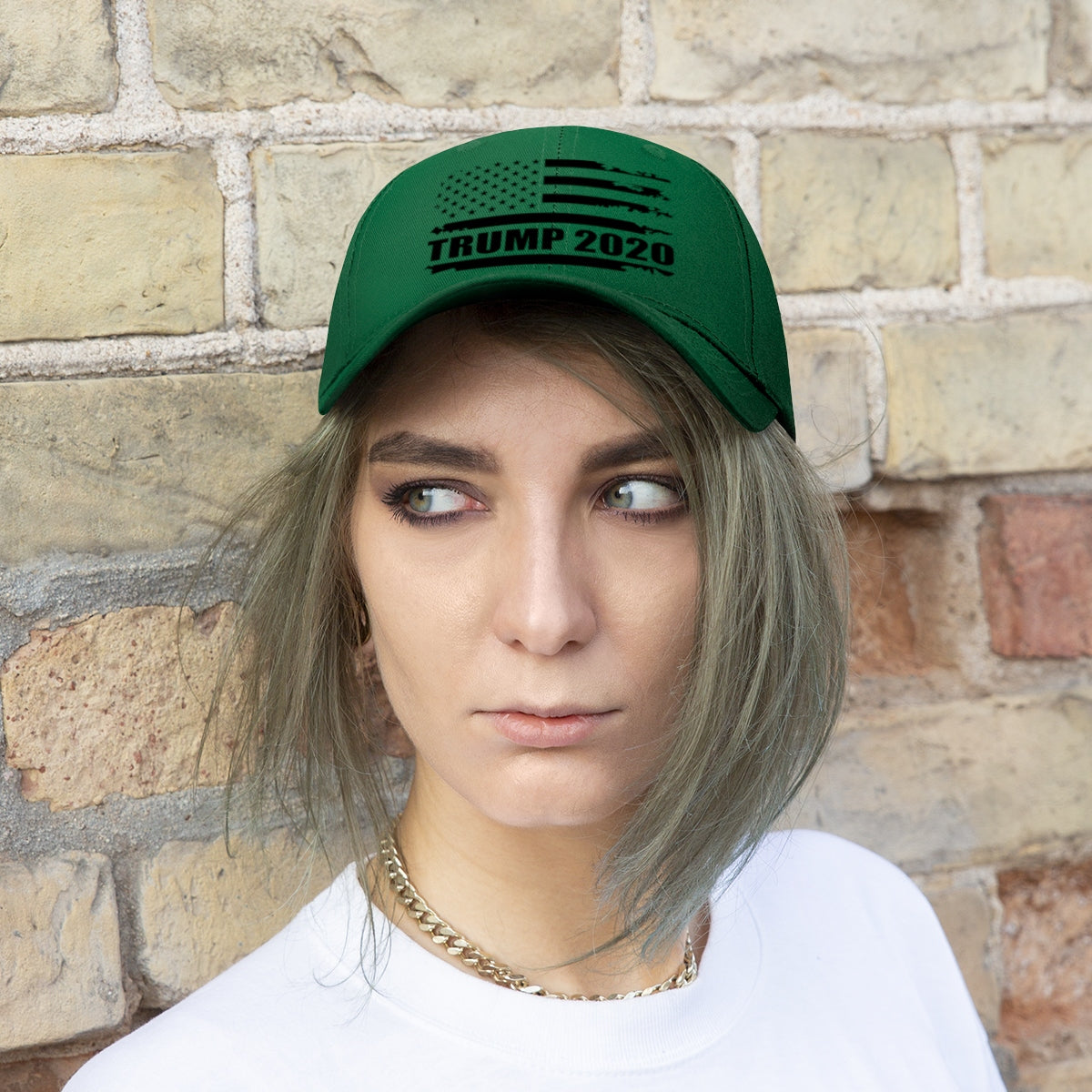 2020 Twill Cap Trump Bold Supporter Cap with green design worn by a model against a brick wall.