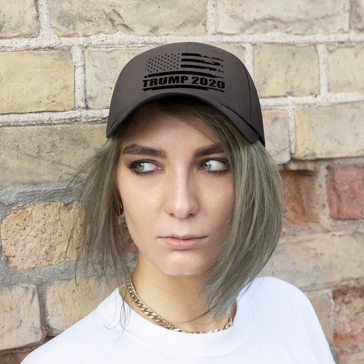 2020 Twill Cap Trump Bold Supporter Cap worn by a person with gray hair against a brick wall.