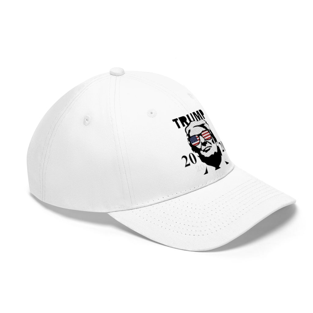 Trump 2020 With US Flag Glasses Twill Cap in white featuring a graphic of Trump wearing US flag glasses.
