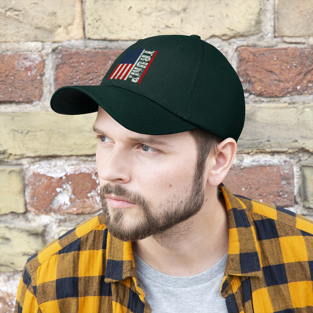 Trump On Verticle Distressed American Flag Twill Cap worn by man against brick background.