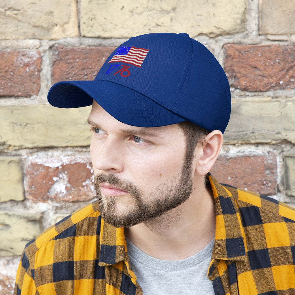 Man wearing Betsy Ross Flag 1776 Twill Cap with brick wall background